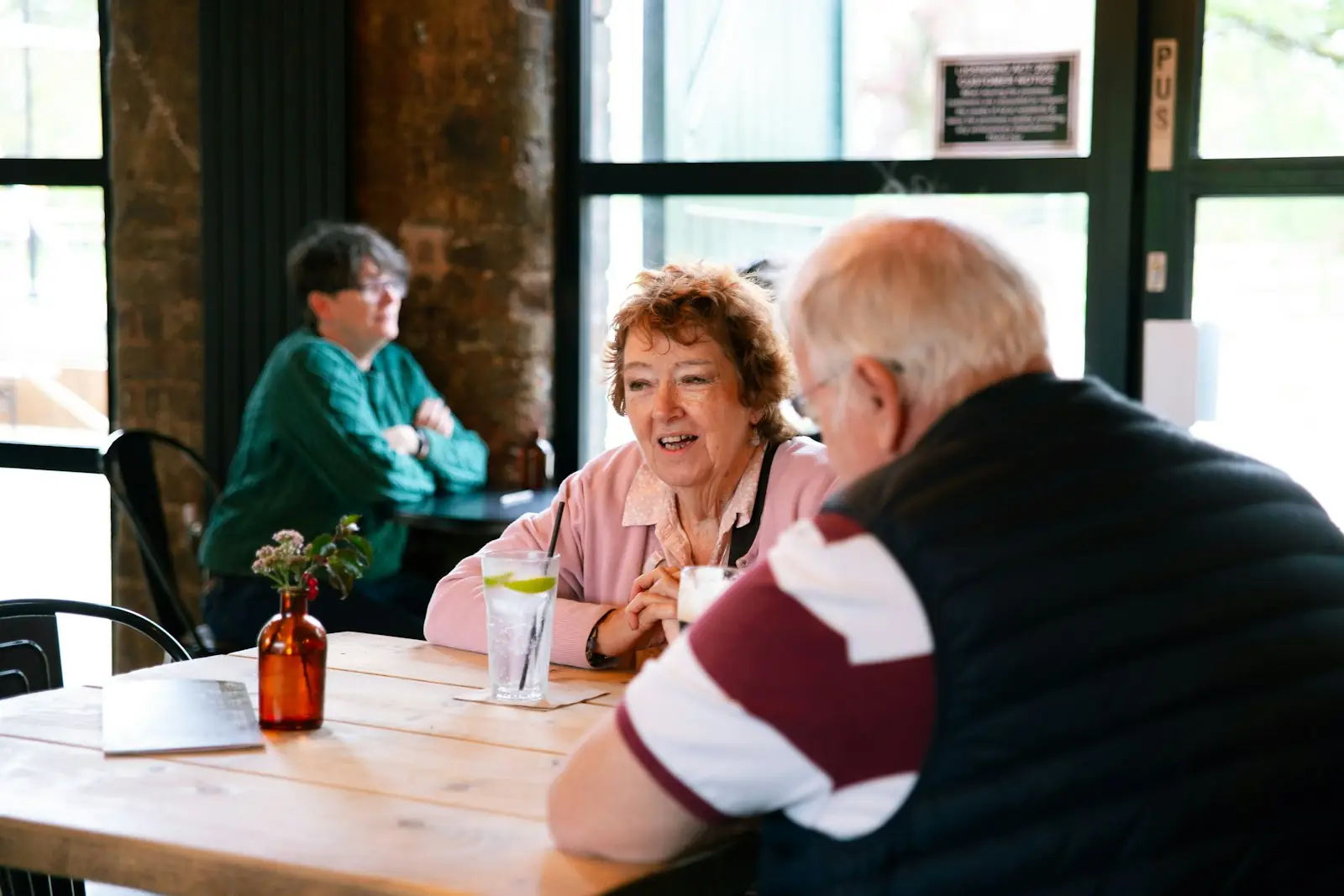 Two couples talking at a cafe table